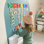 Child playing on the MagPlay Wall + Board Bundle magnetic playwall