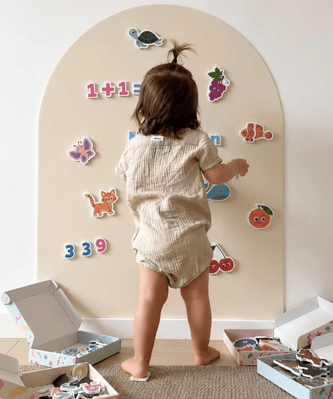 Child playing with magnets on the MagPlay Wall magnetic playwall