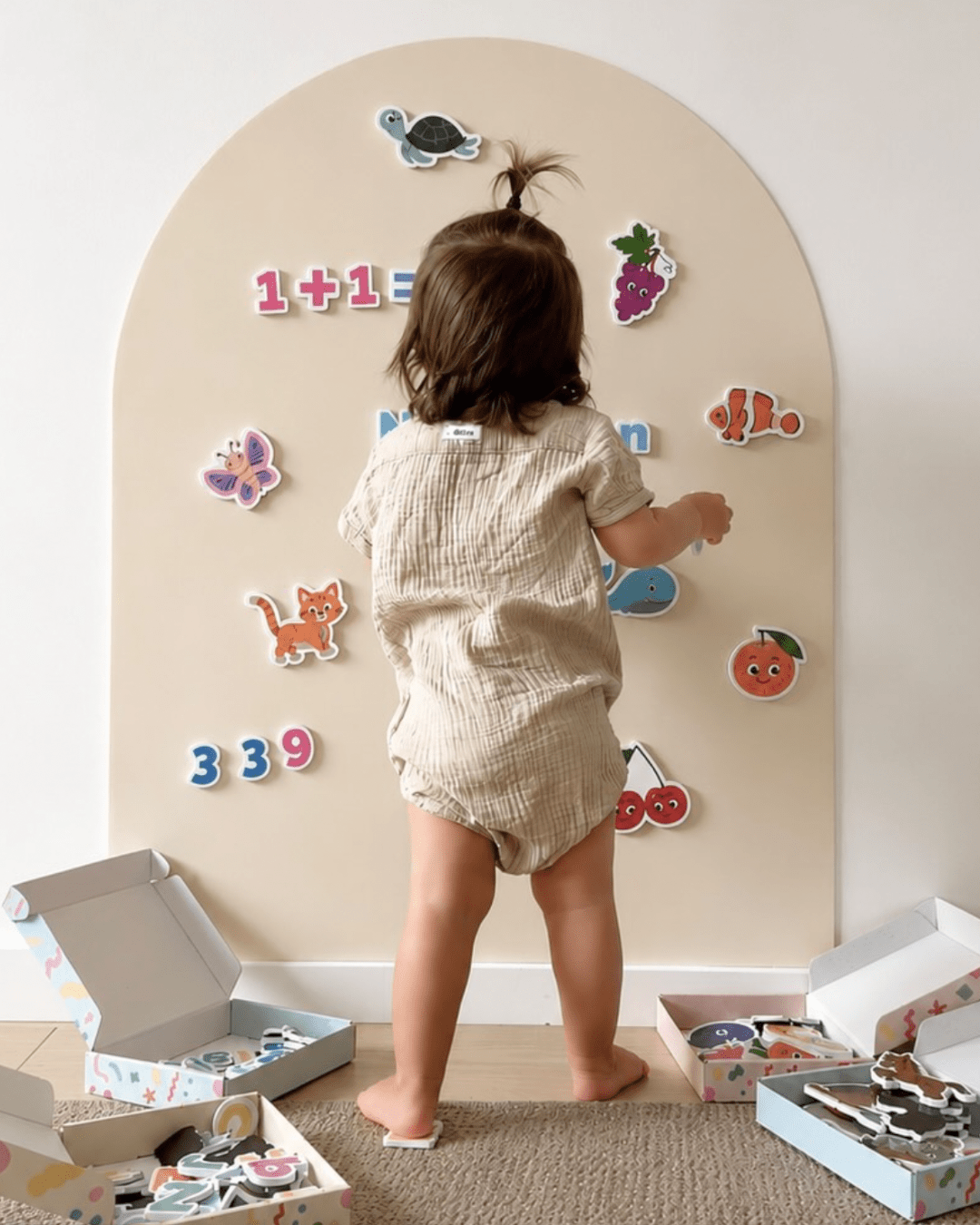 Child playing with magnets on the MagPlay Wall magnetic playwall